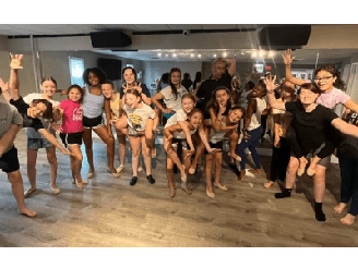 New Project - 2024-04-10T193624.150 A group of childrens dancing on the stage